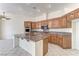 Spacious kitchen with a granite island, wooden cabinetry, and modern appliances at 2725 Cool Lilac Ave, Henderson, NV 89052