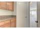Kitchen with wooden cabinets and granite countertops; view into living room at 2725 Cool Lilac Ave, Henderson, NV 89052
