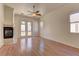 Living room with wood floors, fireplace, and view of the backyard and pool at 2725 Cool Lilac Ave, Henderson, NV 89052