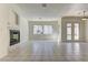 Spacious living room with tiled floors, fireplace, and double doors to the backyard at 2725 Cool Lilac Ave, Henderson, NV 89052