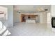 Open-concept living room with tile floors, kitchen, and natural light at 2725 Cool Lilac Ave, Henderson, NV 89052