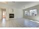 Spacious living room featuring fireplace, tile floors and bright light from backyard windows at 2725 Cool Lilac Ave, Henderson, NV 89052