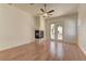 Living room features wood flooring, a fireplace, and glass doors to a patio and pool at 2725 Cool Lilac Ave, Henderson, NV 89052