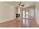 Cozy living room with wood floors, a corner fireplace, and French doors to the patio at 2725 Cool Lilac Ave, Henderson, NV 89052