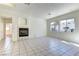 Open living room features a fireplace, tile floors, and large windows providing ample natural light at 2725 Cool Lilac Ave, Henderson, NV 89052