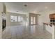 Open concept living room and kitchen area with windows looking to the backyard at 2725 Cool Lilac Ave, Henderson, NV 89052