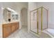 Bright main bathroom with dual sinks, walk-in shower, and jacuzzi tub at 2725 Cool Lilac Ave, Henderson, NV 89052