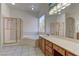 Well-lit bathroom featuring a jetted tub, glass shower, and vanity at 2725 Cool Lilac Ave, Henderson, NV 89052
