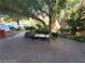 Lovely community courtyard with mature trees and a seating bench at 29 Montelago Blvd # 336, Henderson, NV 89011