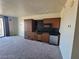 Efficient kitchenette boasts modern cabinets, a microwave, compact refrigerator, and practical black countertops at 29 Montelago Blvd # 336, Henderson, NV 89011