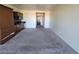 Spacious living area with neutral carpet and wall colors, and a well-equipped kitchenette in the background at 29 Montelago Blvd # 336, Henderson, NV 89011