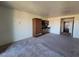 Living room featuring kitchenette with cabinetry and carpeted floor at 29 Montelago Blvd # 336, Henderson, NV 89011