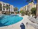 Inviting in-ground pool with deck chairs and surrounding buildings on a sunny day at 29 Montelago Blvd # 336, Henderson, NV 89011