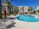 Resort-style pool with lounge chairs surrounded by lush landscaping and multi-story condo buildings at 29 Montelago Blvd # 336, Henderson, NV 89011