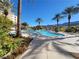 Beautiful community pool featuring multiple palm trees, lounge chairs, and clear blue water at 29 Montelago Blvd # 336, Henderson, NV 89011