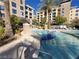 In-ground pool with adjacent hot tub, surrounded by palm trees and condo buildings at 29 Montelago Blvd # 336, Henderson, NV 89011