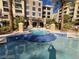 In-ground pool and spa with blue tile accents, set among palm trees and upscale condo buildings at 29 Montelago Blvd # 336, Henderson, NV 89011