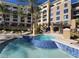 Inviting in-ground pool with attached spa area with blue tile detailing in an upscale condo complex at 29 Montelago Blvd # 336, Henderson, NV 89011