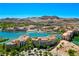 Picturesque aerial view of a lakeside community with multiple buildings and a stunning mountain backdrop at 29 Montelago Blvd # 520, Henderson, NV 89011