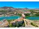 Picturesque aerial view of a lakeside community with multiple buildings and stunning mountain backdrop at 29 Montelago Blvd # 520, Henderson, NV 89011
