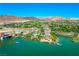 Scenic aerial shot of the lakefront community featuring a bridge, pool, and stunning mountain views in the background at 29 Montelago Blvd # 520, Henderson, NV 89011