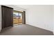 Bedroom with neutral carpet, large sliding glass doors leading to a balcony, and views of the hills at 29 Montelago Blvd # 520, Henderson, NV 89011