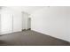 Bright bedroom featuring neutral gray carpet, white walls and baseboards, and a sliding closet door at 29 Montelago Blvd # 520, Henderson, NV 89011