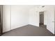 Bedroom with neutral carpet and baseboards, white walls, and a doorway leading to another room at 29 Montelago Blvd # 520, Henderson, NV 89011