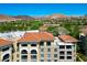 Luxury condominium complex with terracotta roofs and stucco walls, surrounded by a lush green golf course at 29 Montelago Blvd # 520, Henderson, NV 89011