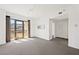 Inviting living room with large windows, carpet flooring, and access to balcony at 29 Montelago Blvd # 520, Henderson, NV 89011