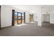 Bright, open living room with a wall of windows offering scenic views and a seamless transition to a dining area at 29 Montelago Blvd # 520, Henderson, NV 89011