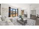 Bright living room featuring large windows with scenic views, stylish furnishings, and open floorplan connecting dining area at 29 Montelago Blvd # 520, Henderson, NV 89011