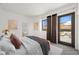 Inviting main bedroom with a private balcony, neutral decor, and ensuite bath with modern fixtures and finishes at 29 Montelago Blvd # 520, Henderson, NV 89011