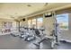 Well-equipped fitness center with cardio machines, ample natural light, and ceiling fans at 2900 Sunridge Heights Pkwy # 518, Henderson, NV 89052