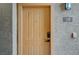 This tan-painted front door features a modern smart lock and a peephole for added security and convenience at 2900 Sunridge Heights Pkwy # 518, Henderson, NV 89052