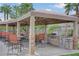 Outdoor grilling area with built-in grill, stone accents, seating, and overhead shade structure at 2900 Sunridge Heights Pkwy # 518, Henderson, NV 89052