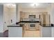 Charming kitchen boasts stainless steel appliances and black countertops, perfect for culinary adventures and meal preparation at 2900 Sunridge Heights Pkwy # 518, Henderson, NV 89052