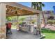 Outdoor grill and dining area featuring a built-in grill, counter space, and comfortable seating under a covered gazebo at 2900 Sunridge Heights Pkwy # 518, Henderson, NV 89052