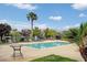 Community pool with lounge chairs and palm trees at 2900 Sunridge Heights Pkwy # 518, Henderson, NV 89052