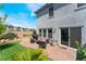 Backyard features a stone patio, artificial turf, and desert landscaping at 2935 Saltillo Ln, Las Vegas, NV 89121