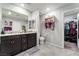 Bathroom with double vanity sinks, tile floors, and a walk-in closet at 2935 Saltillo Ln, Las Vegas, NV 89121