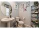 Cozy half bathroom features pedestal sink, decorative shelving, and neutral decor for a clean, modern look at 2935 Saltillo Ln, Las Vegas, NV 89121