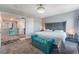 This bedroom boasts a spacious layout, soft carpet, and natural light, complemented by a tufted headboard at 2935 Saltillo Ln, Las Vegas, NV 89121