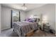 Comfortable bedroom with neutral walls, carpet flooring, and a view of the outside at 2935 Saltillo Ln, Las Vegas, NV 89121