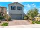Inviting two-story home with a tidy front yard, a brick driveway, and a two-car garage at 2935 Saltillo Ln, Las Vegas, NV 89121