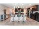 Modern kitchen featuring dark cabinets, a spacious island, and stainless steel appliances at 2935 Saltillo Ln, Las Vegas, NV 89121