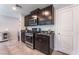 Functional kitchen equipped with dark cabinets, granite countertops, and stainless steel appliances for modern cooking at 2935 Saltillo Ln, Las Vegas, NV 89121