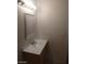 A half bathroom with modern lighting, vanity, framed mirror, and white walls at 2981 Country Manor Ln # 118, Las Vegas, NV 89115