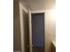 A hallway with white walls and beige tiled flooring leading to a white door at 2981 Country Manor Ln # 118, Las Vegas, NV 89115