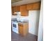 Compact kitchen features light wood cabinets and white appliances at 2981 Country Manor Ln # 118, Las Vegas, NV 89115